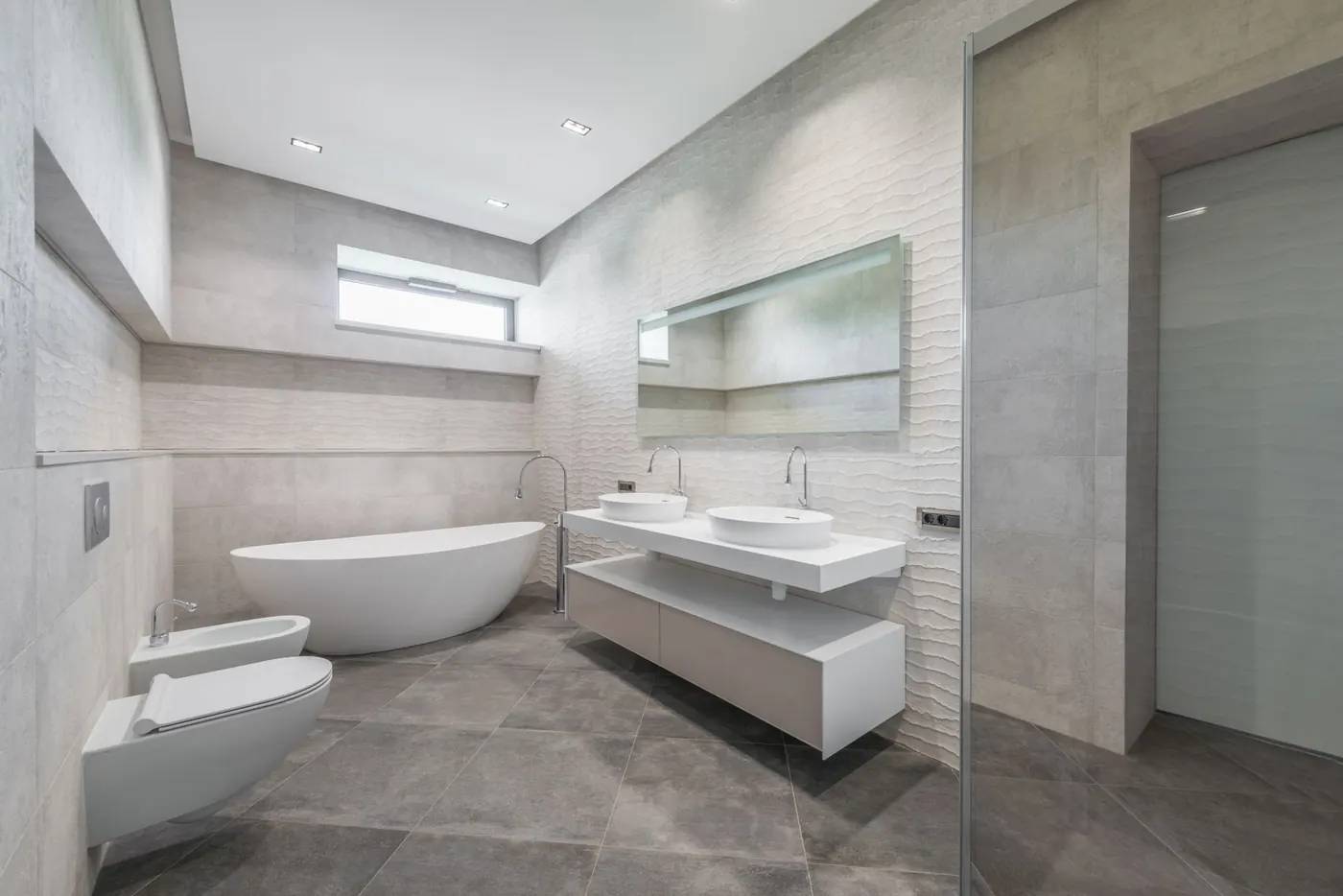 Light, spacious bathroom with a freestanding tub and double-sink vanity